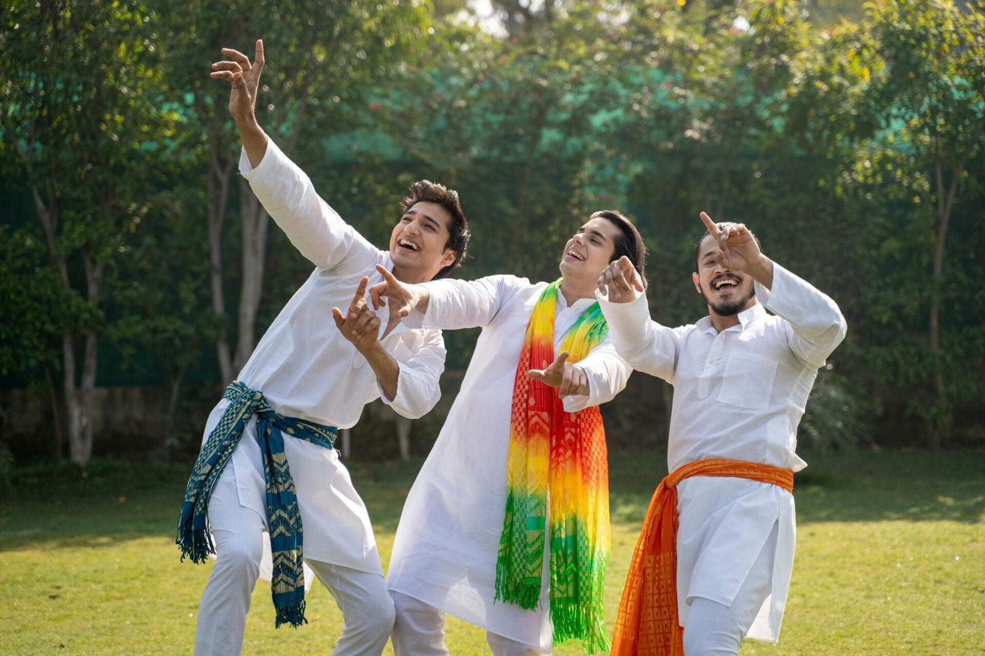 Three men in traditional clothing celebrate outdoors with energetic joy and colorful scarves. Investment and Turnover