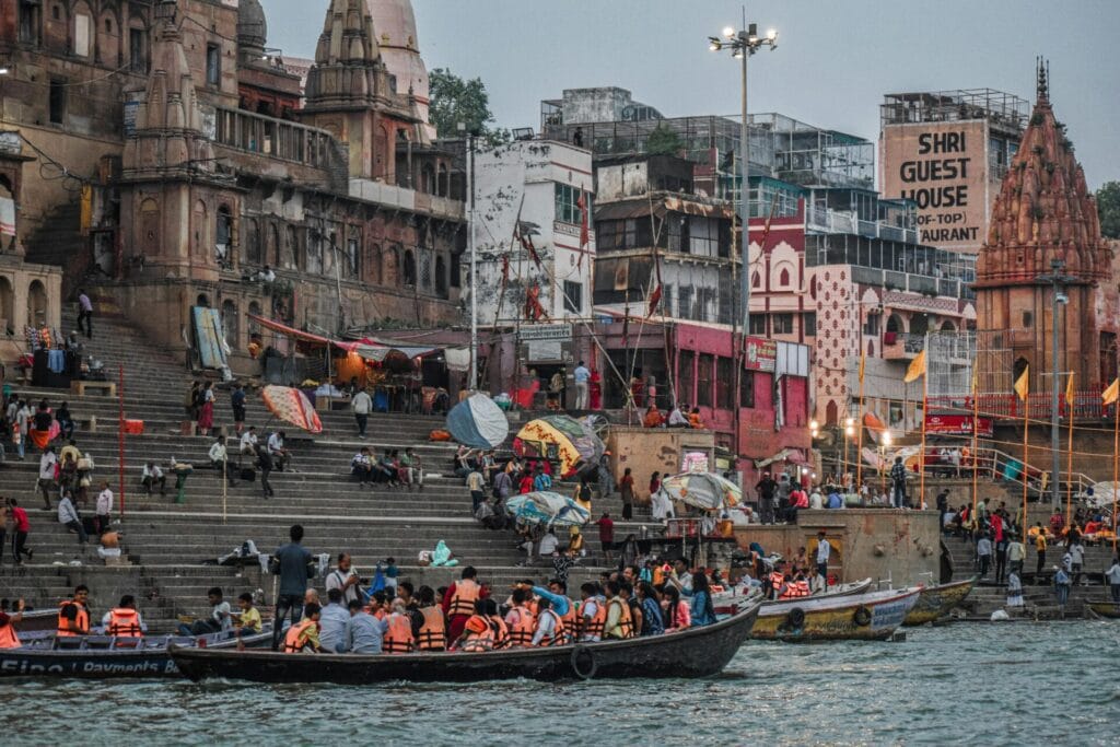 Lively scene of boats and people along the Ganges riverfront in Varanasi, India. IndiaAI Mission review
